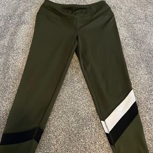 Green athletic leggings with design in the bottom front